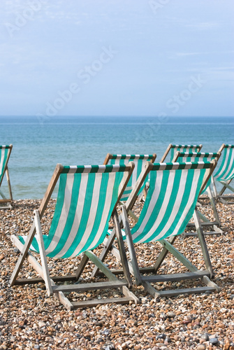 Striped Deckchairs on Pebbled Beach