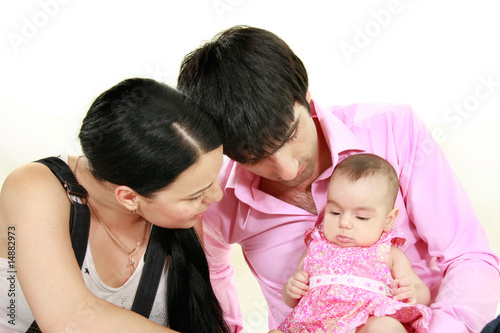 young parents with baby girl over white