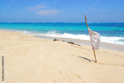Fototapeta Naklejka Na Ścianę i Meble -  whiteflag sign on tropical beach on cuba