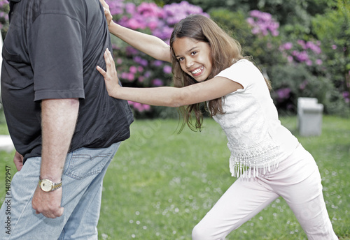 Girl pushing her grandpa photo
