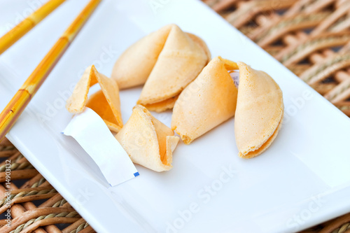 Chinese Fortune Cookie with blank paper on white dish