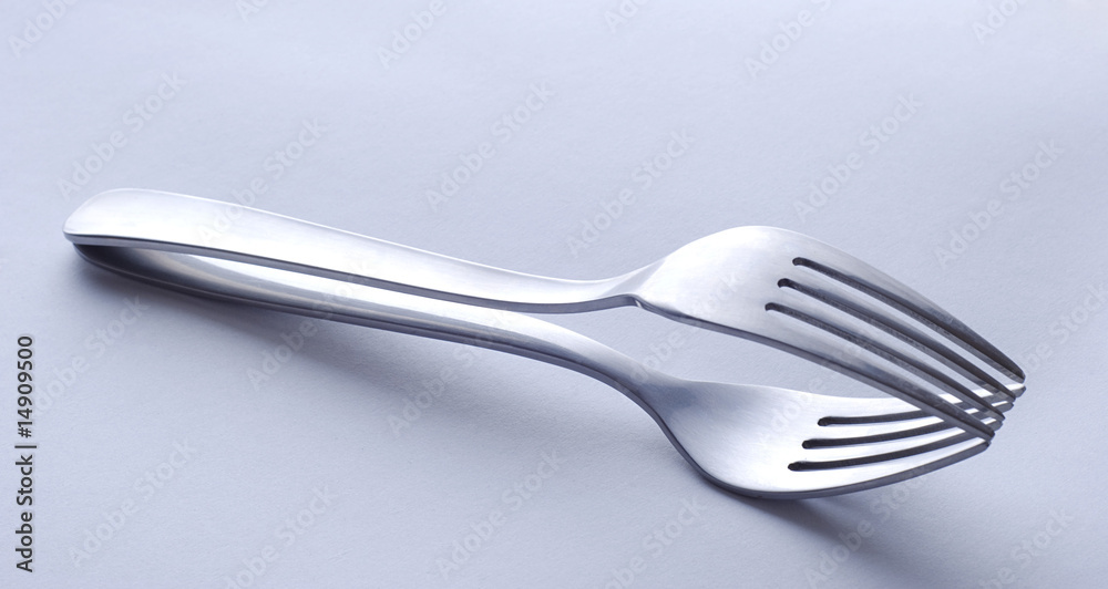 Two forks laying one over another Two forks laying one over another