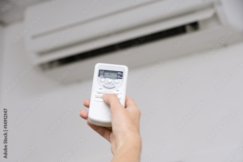 Fototapeta premium Hand of woman includes air-conditioner