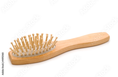 Natural wood massage hairbrush over white background