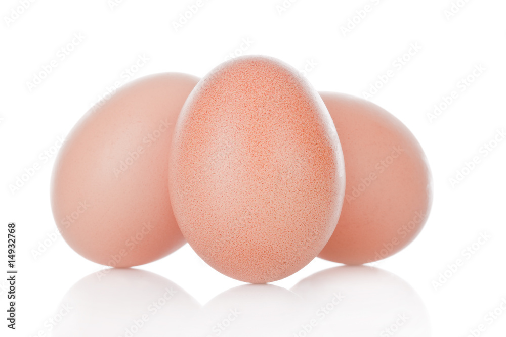 Three brown chicken eggs isolated on white background Three brown chicken eggs isolated on white background