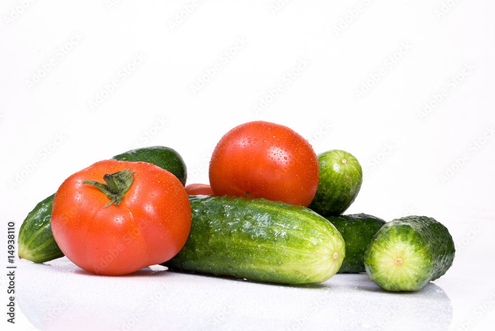 Cucumbers and tomato, isolated on white background Cucumbers and tomato, isolated on white background