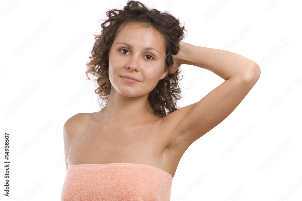 Fototapeta premium Beautiful brunette woman wearing peach-coloured bath towel.