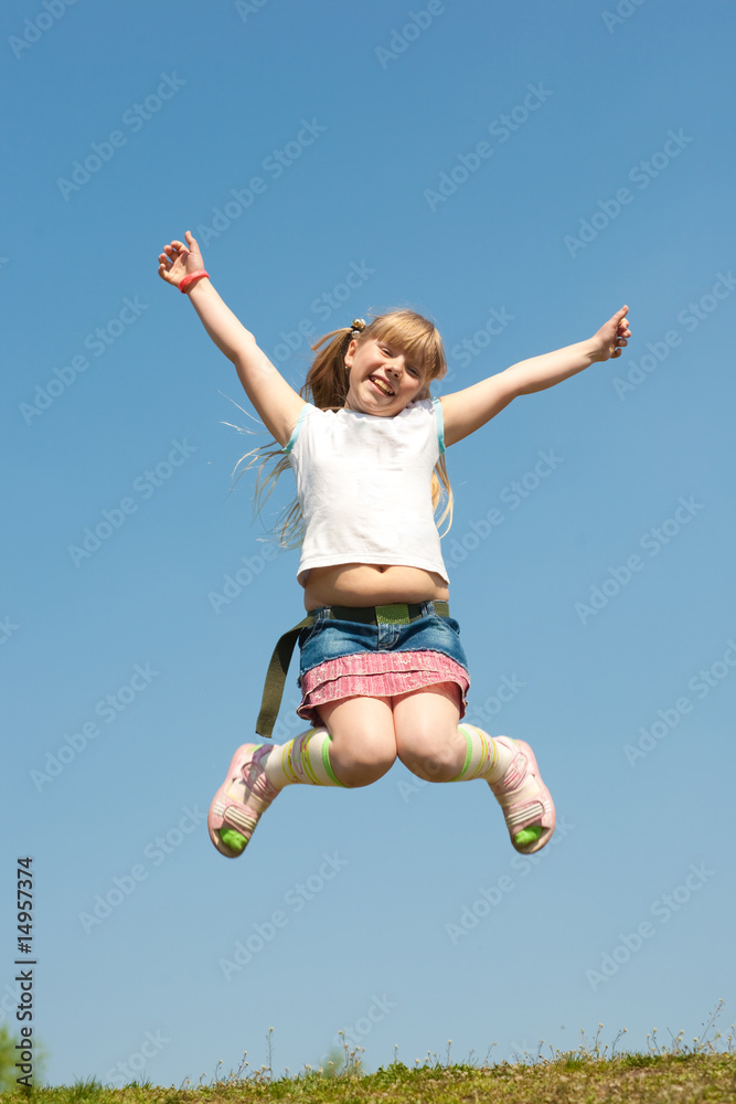 Little girl jumping against beautiful sky Little girl jumping against beautiful sky