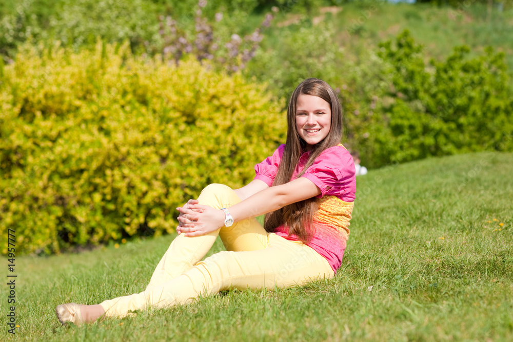 Pretty smiling girl relaxing on green meadow. Soft focus. Focus Pretty smiling girl relaxing on green meadow. Soft focus. Focus