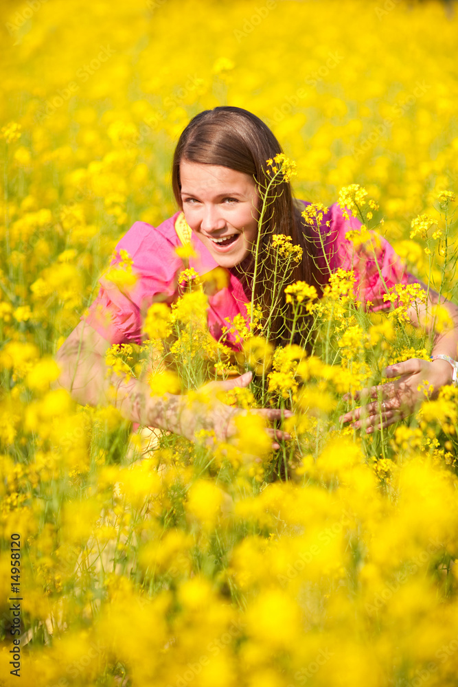 Pretty smiling girl relaxing on green meadow full of flowers. So Pretty smiling girl relaxing on green meadow full of flowers. So