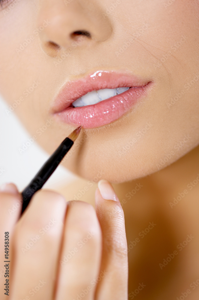 Portrait of beautiful woman doing makeup