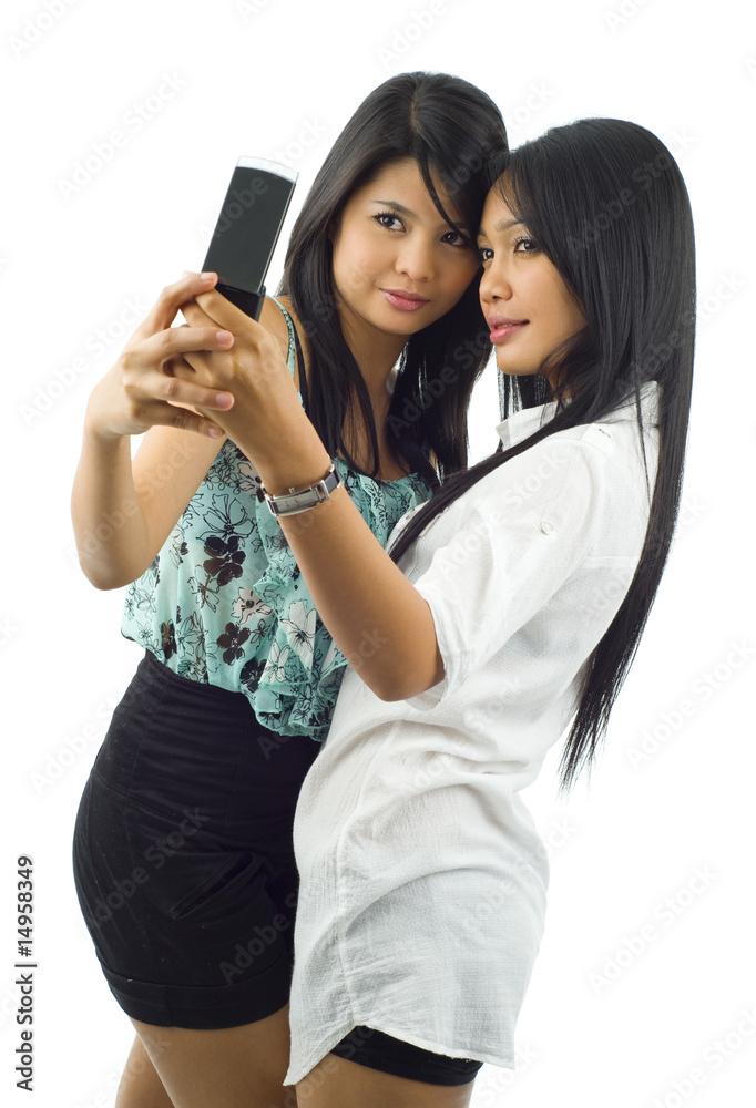 two asian women taking a picture of themselves