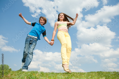Girl and boy jumping