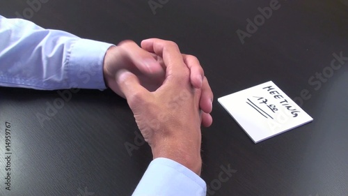 business man twiddles his thumbs