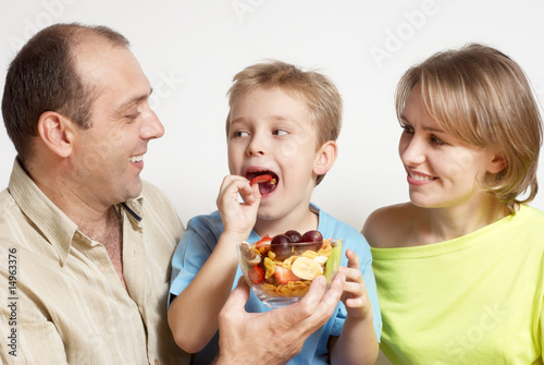 Happy family with fruit salad