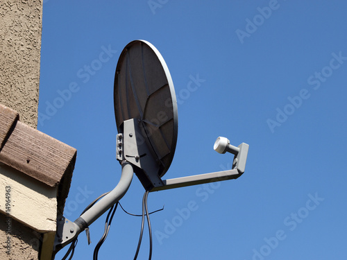 Satelite dish attached to house from back side photo