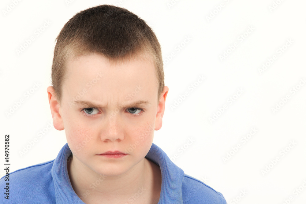 Portrait of unhappy young boy, studio shot Portrait of unhappy young boy, studio shot