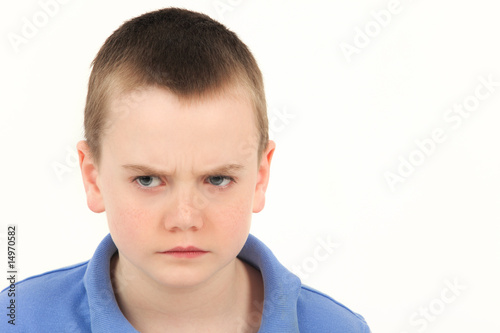 Portrait of unhappy young boy, studio shot