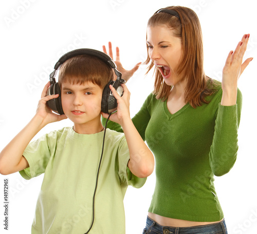 Sister screaming at her brother listerning to the music. Isolate