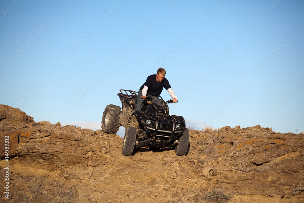 Obraz premium teen on ATV quad in the hills