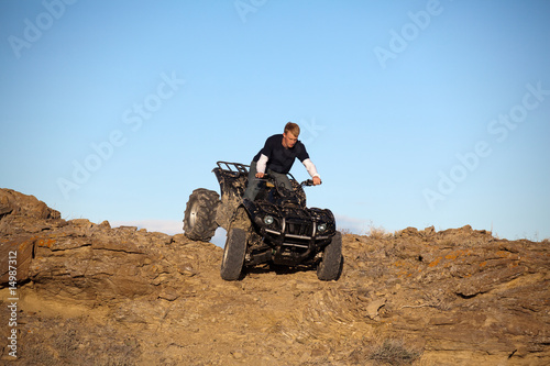 teen on ATV quad in the hills