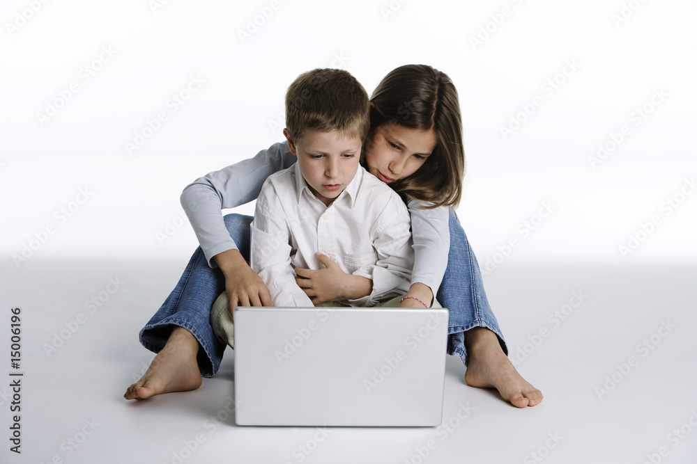 Fotografie Boy and girl with laptop computer