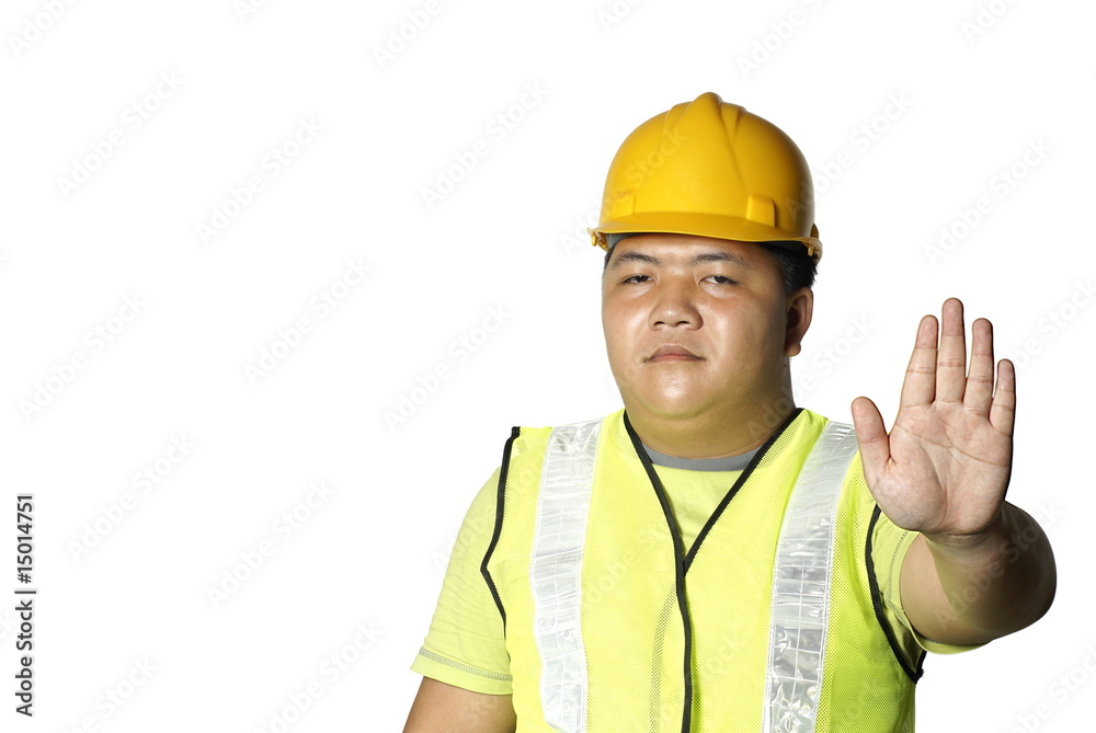 Asian construction worker with stop hand signal Asian construction worker with stop hand signal