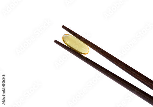 Two chopsticks holding  omega-3 vitamin