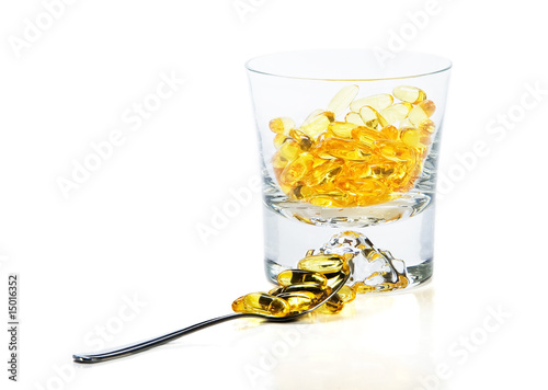 Omega-3 vitamins in glass  and teaspoon