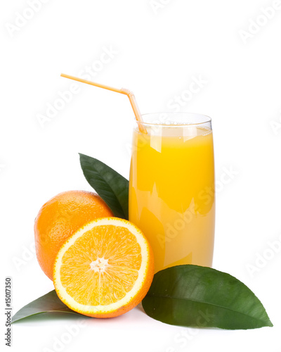 Fruits with green leaves and glass of juice