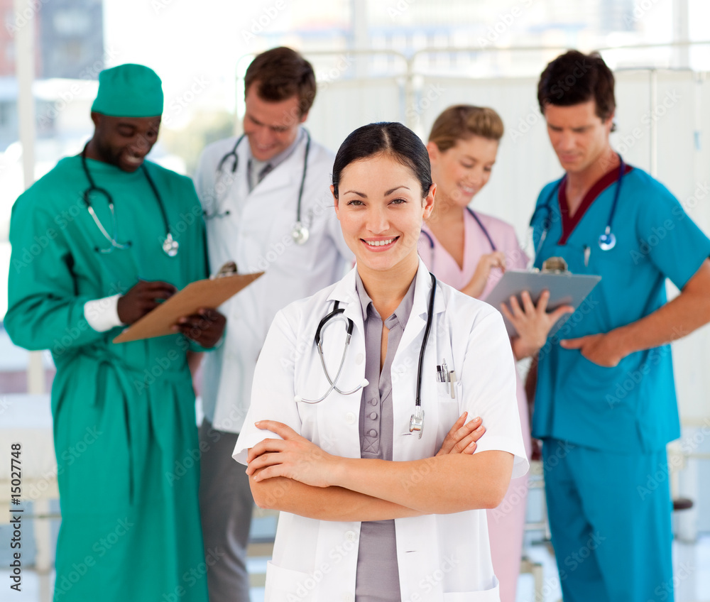 Attractive female doctor with her team Attractive female doctor with her team