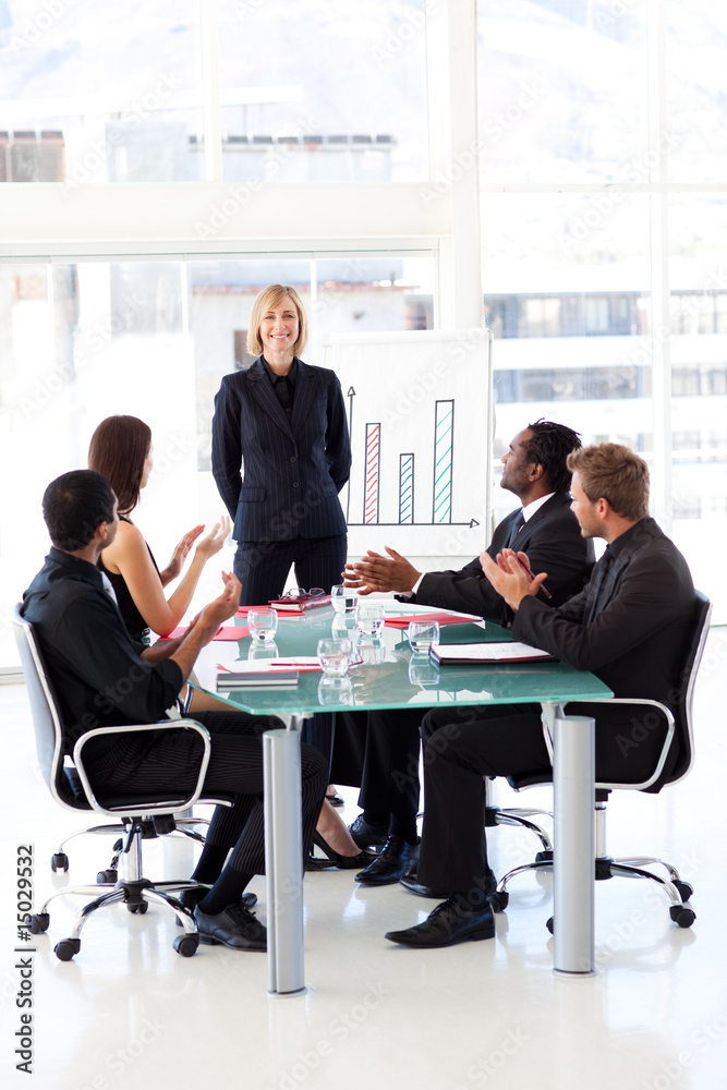 Businesspeople clapping in a meeting Businesspeople clapping in a meeting