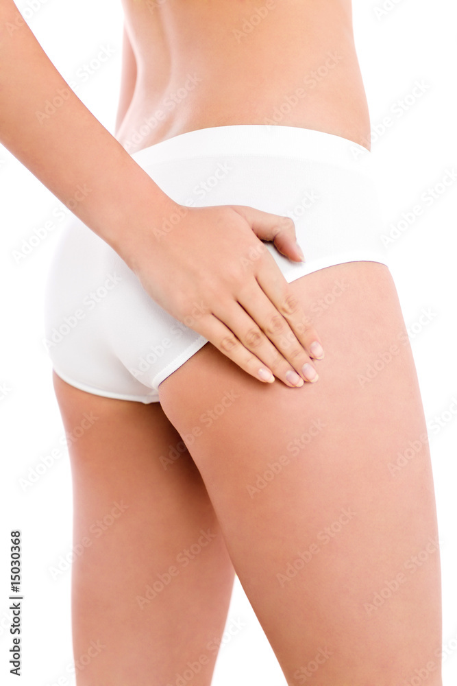 Slim woman touching her thigh