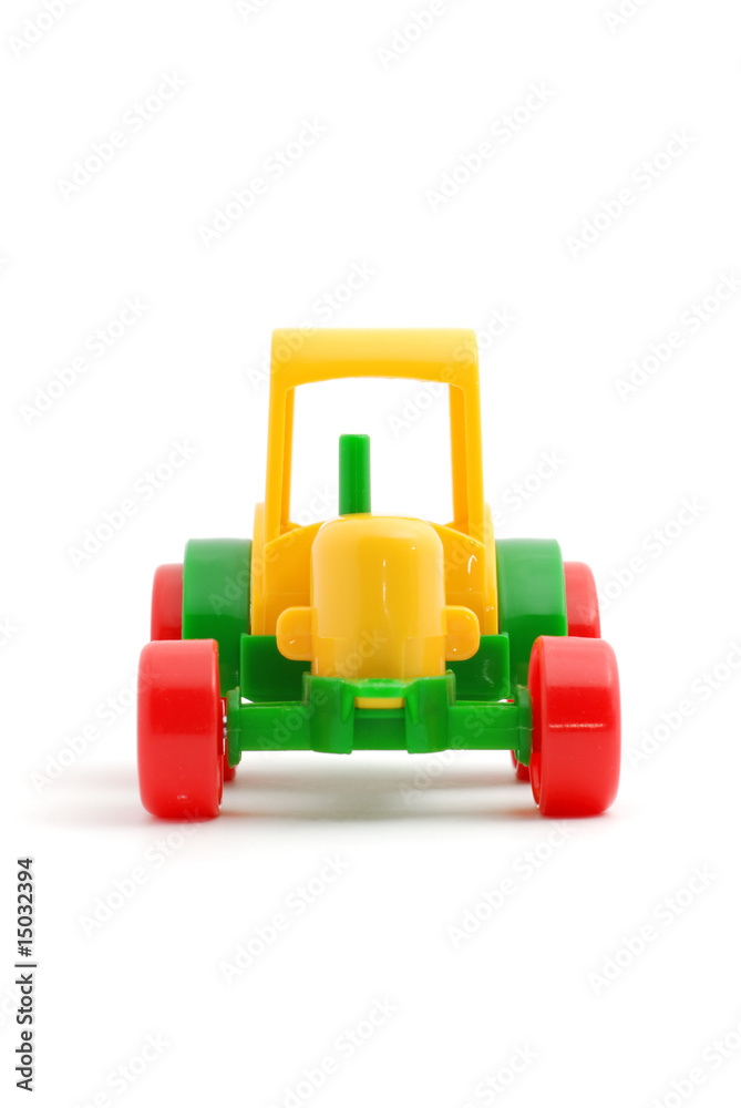 Small toy tractor isolated on white