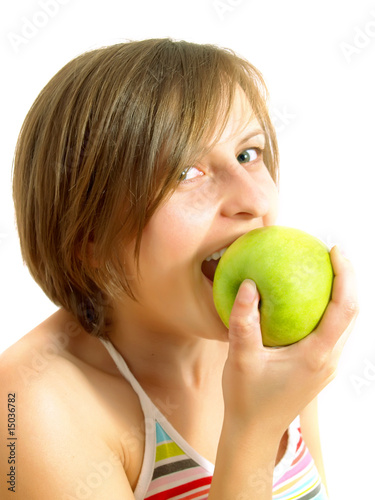 Cute girl biting a green apple