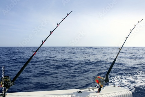 Fishing rod and reel on boat in blue ocean