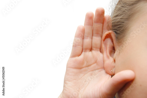 Girl listening with her hand on an ear