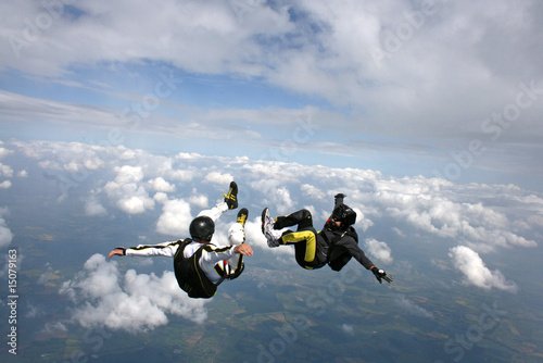 Two skydivers in a sit position