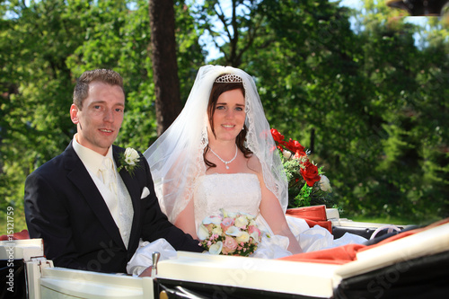 young couple after wedding in a nice wedding carriage
