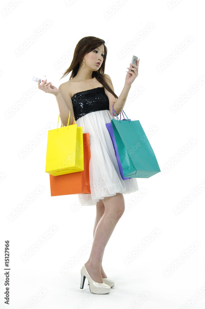 young woman holding a mobile and shopping bags young woman holding a mobile and shopping bags