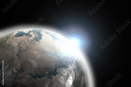 Sun emerging over planet earth