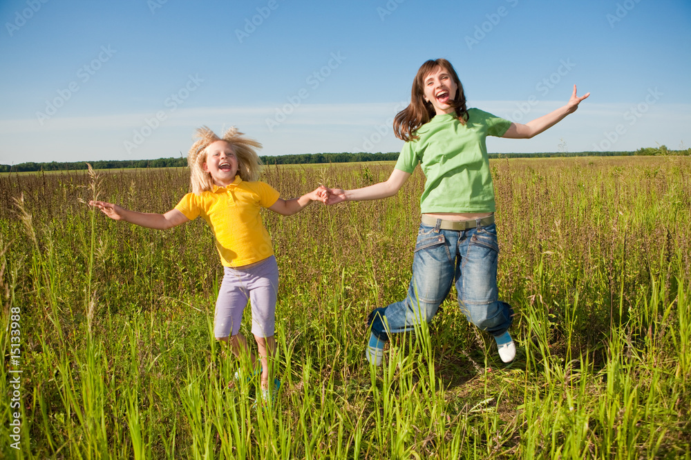 Happy mother and daughter at field