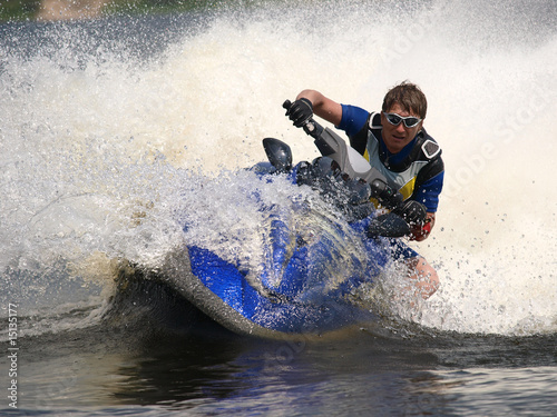 Man on jet-ski turns very fast with diving photo