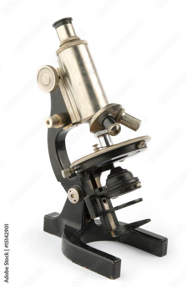 old microscope on white background
