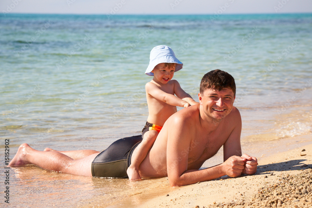 Fotografie son sit astride a father