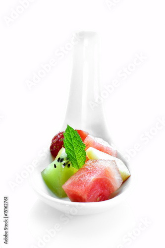 spoon with pieces of fresh fruit