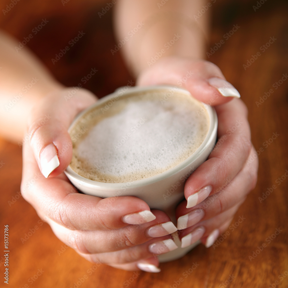 cup of coffee with milk in hands cup of coffee with milk in hands