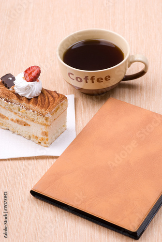 cake with cup of coffee and book