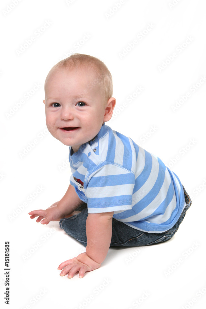 Smiling Bright Baby Boy Sitting and Looking Back Smiling Bright Baby Boy Sitting and Looking Back
