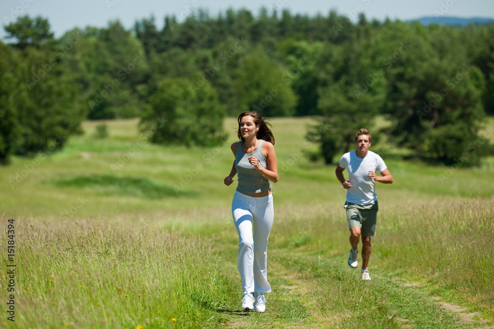 Young woman with headphones jogging